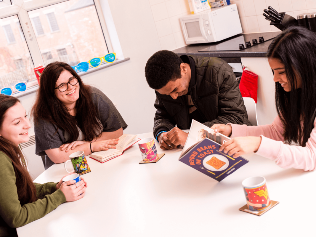 Students sit round a table