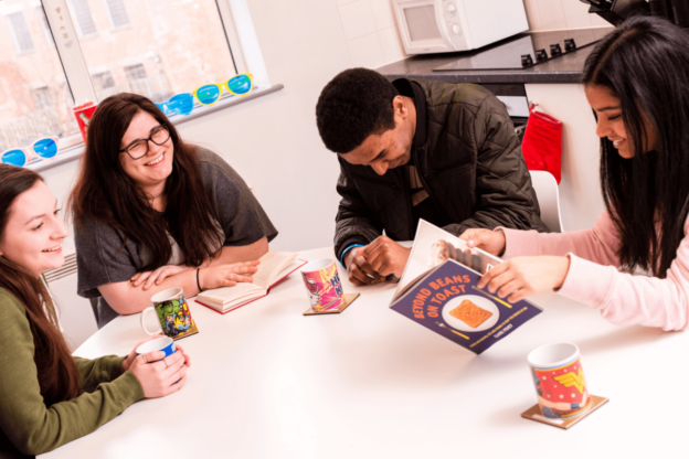 Students sit round a table