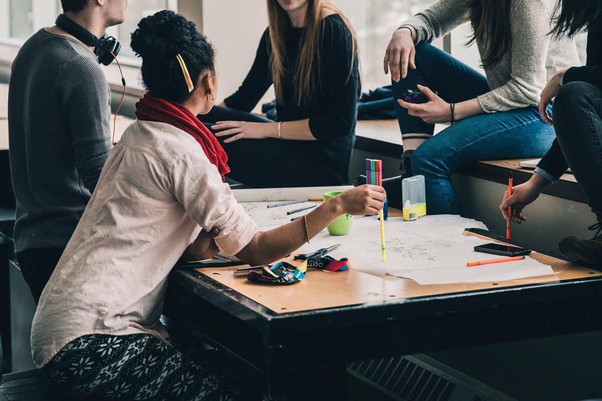 Students brainstorming around a desk