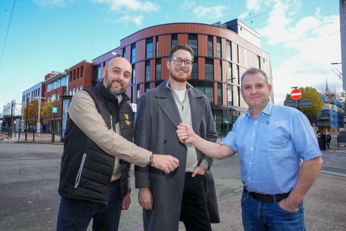 A representative from the college, council and contractor outside the new college building