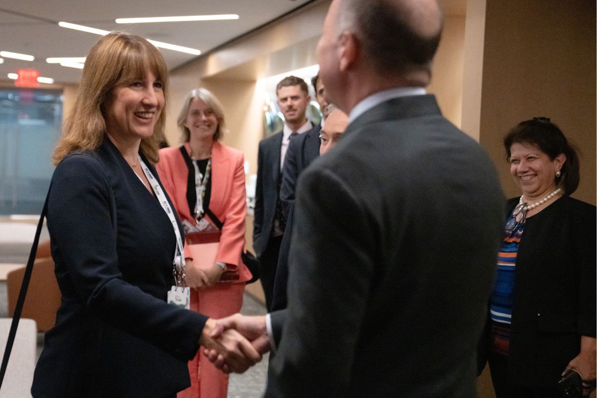 Reeves shaking hands at IMF