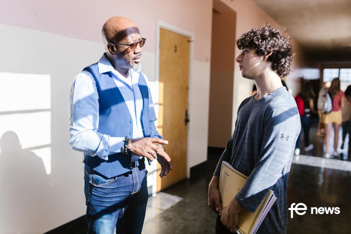 Teacher chatting to Student in hallway