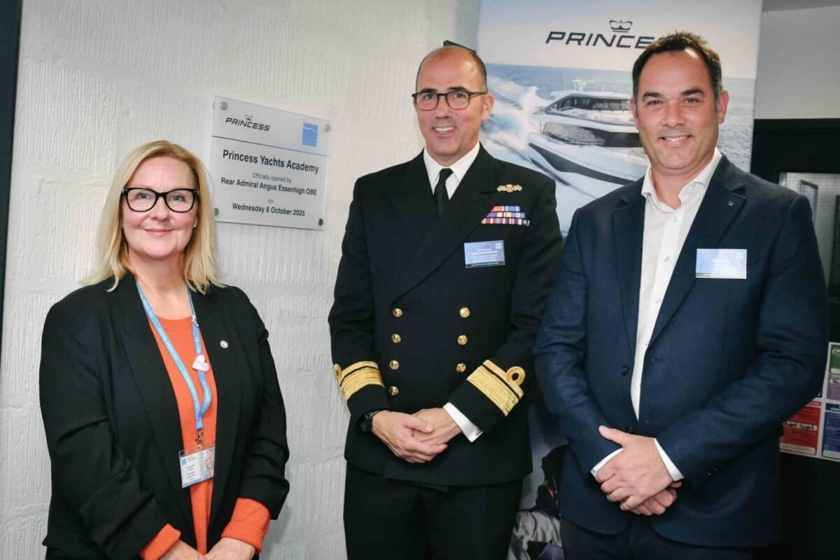 Three people - one woman and two men - stood in front of the Princess Yachts Academy plaque