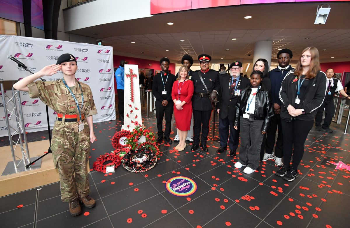 Sandwell College student in army uniform salutes next to the college principal, deputy lieutenant, war veteran and students