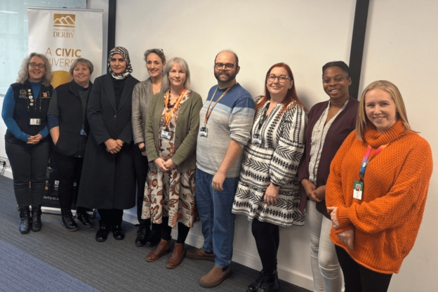 Smiling people are standing in a row