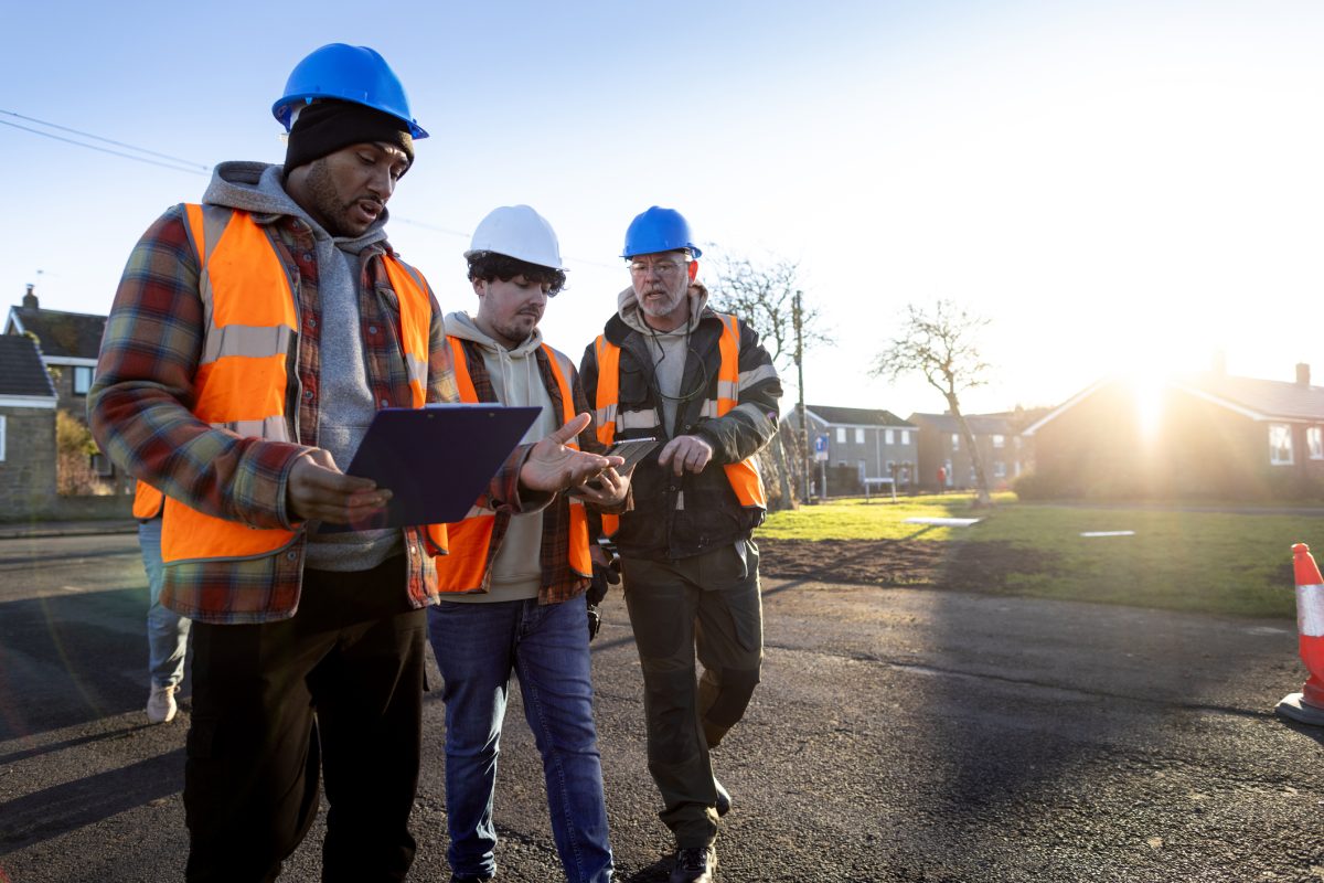 NOCN Istock three builders in high vis and hard hats planning outside