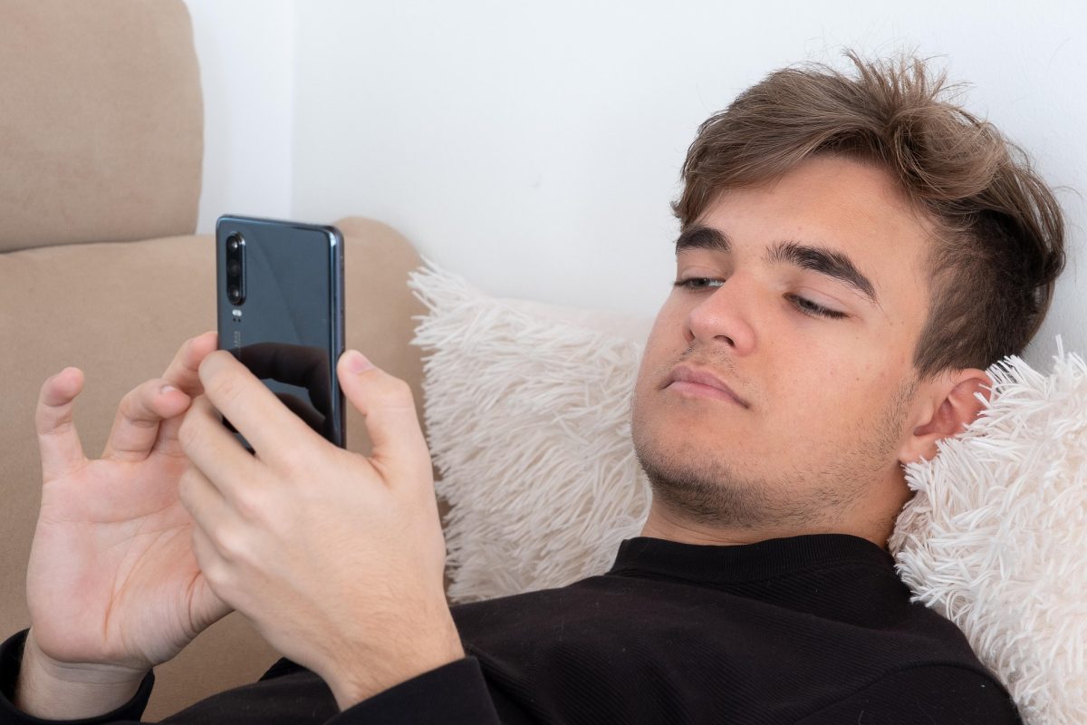 Teen on sofa on mobile phone