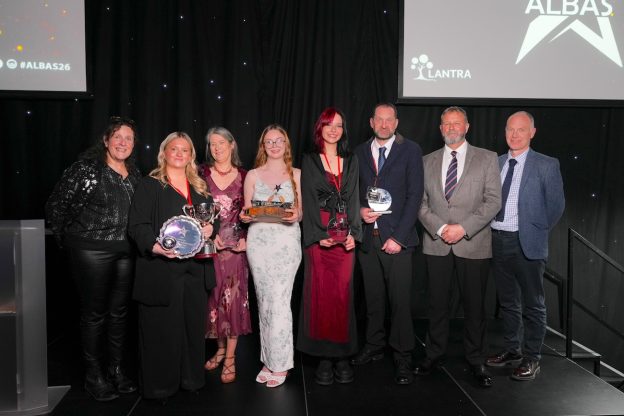 Group of Borders College staff and students standing on a stage at the ALBAS