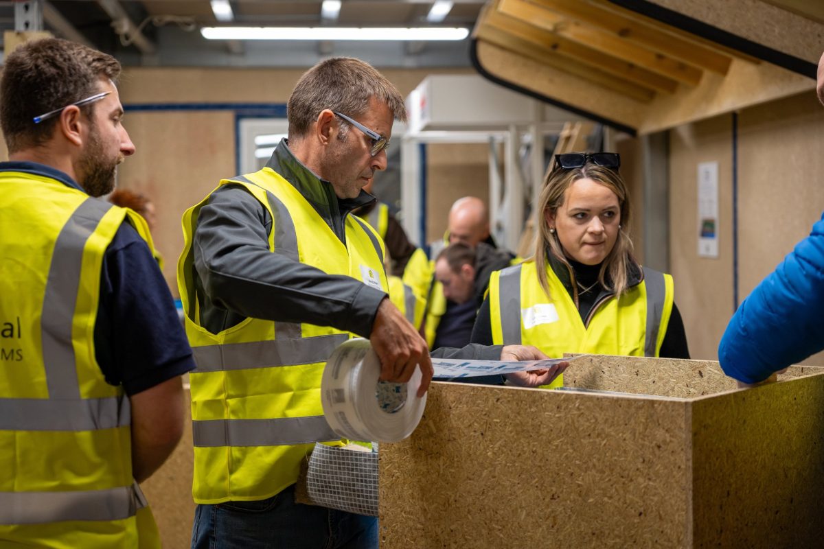 Group of people working in a construction workshop environment