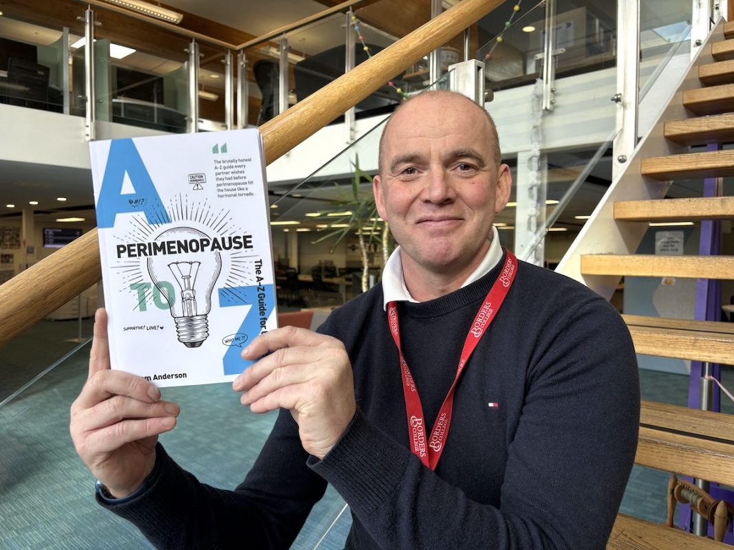 Photo of Sam Anderson holding his new booklet