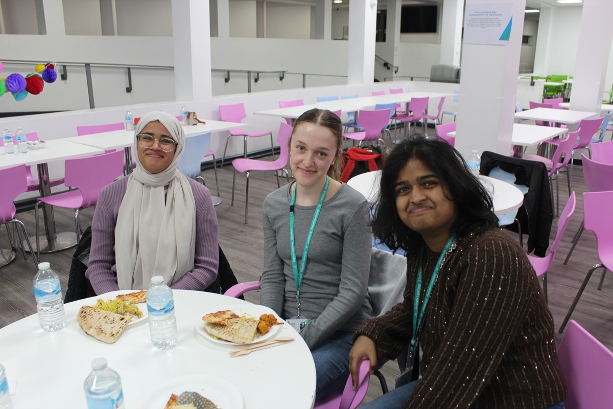 Three female students enjoying taking part in the Community Iftar Meal at Reading College