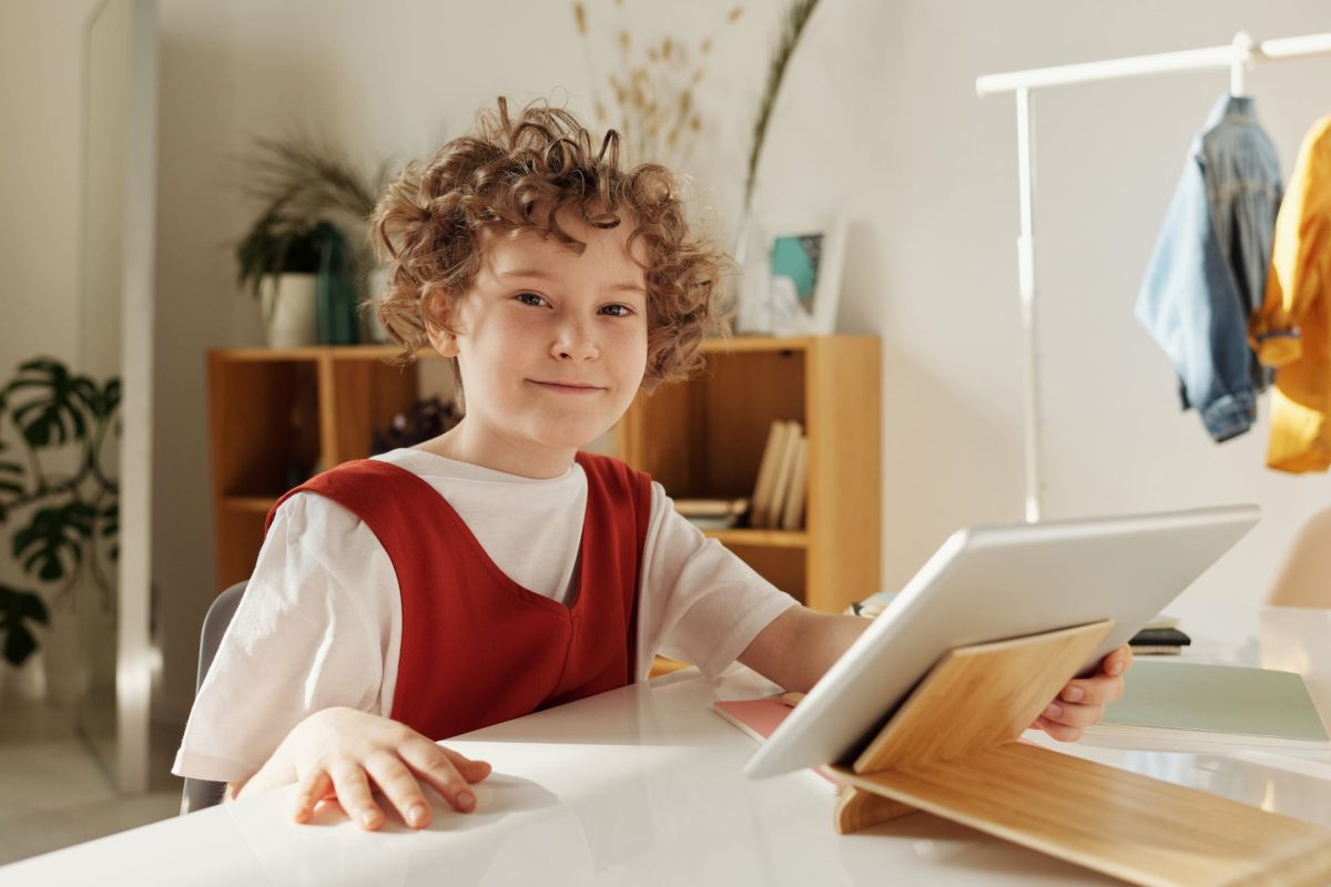 Young person in a classroom with an iPad