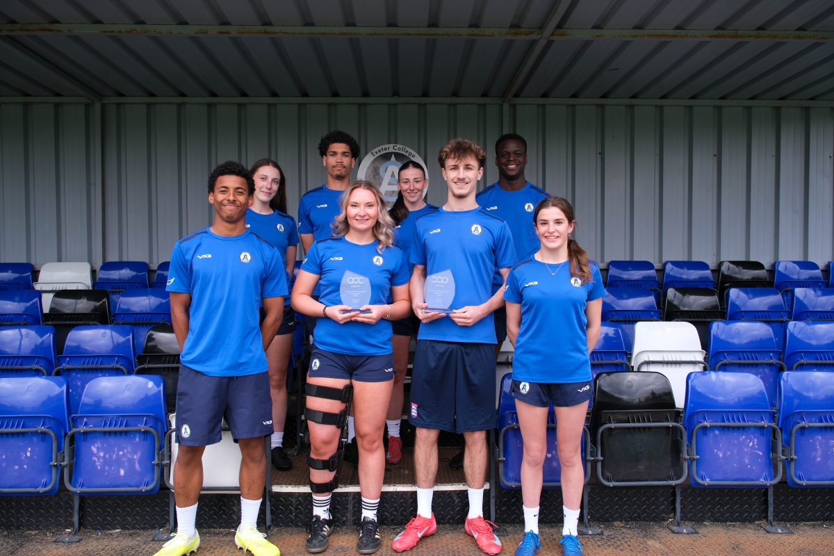 Exeter College footballers hold up a trophy