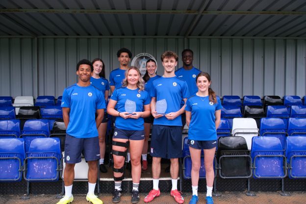 Exeter College footballers hold up a trophy