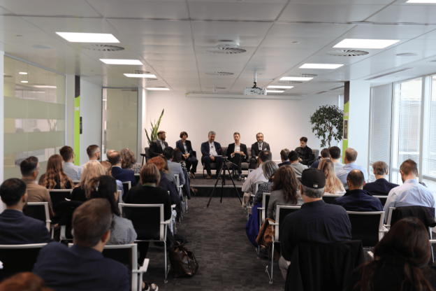 People in a room watching a talk at the techUK event