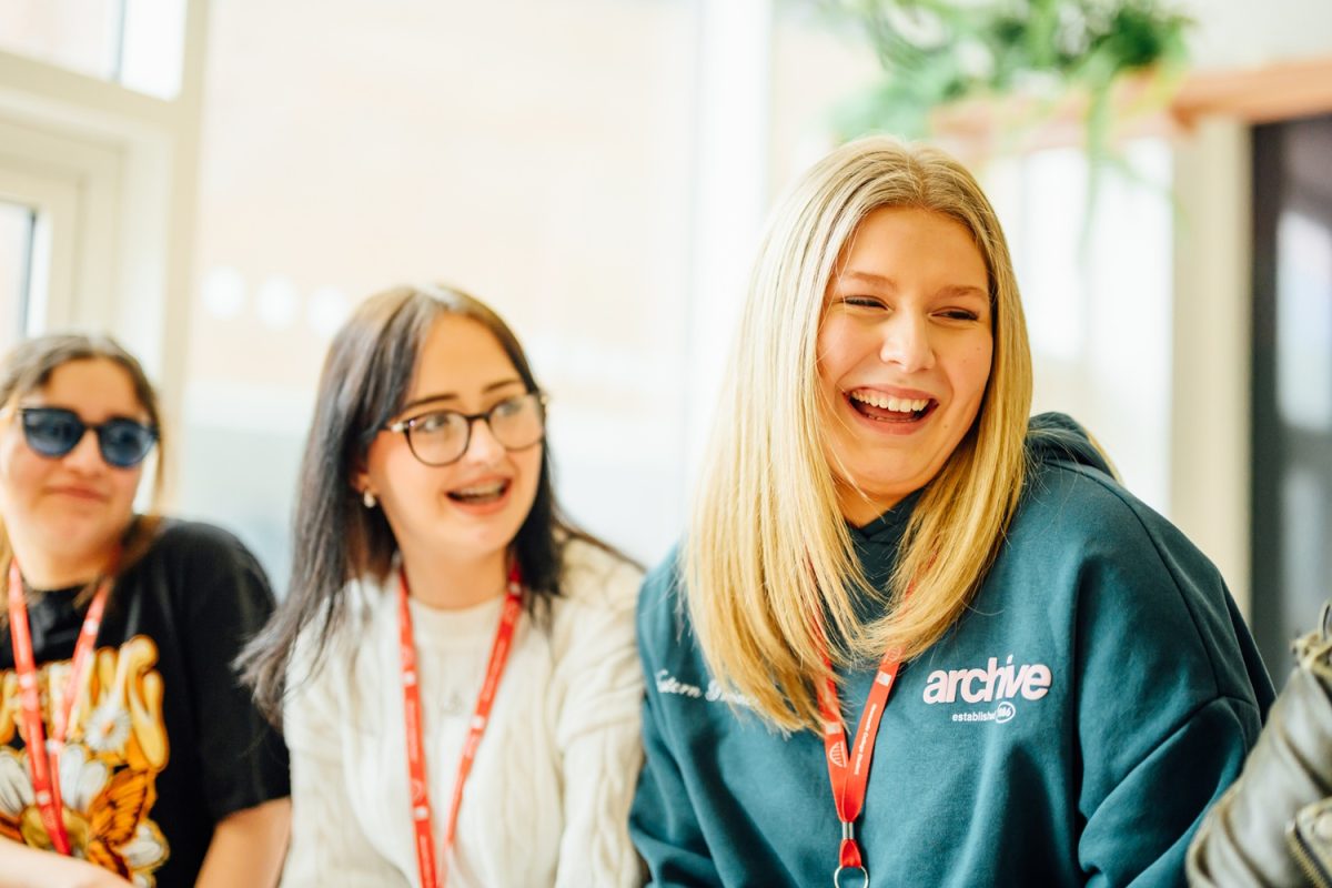 Image shows two girls smiling