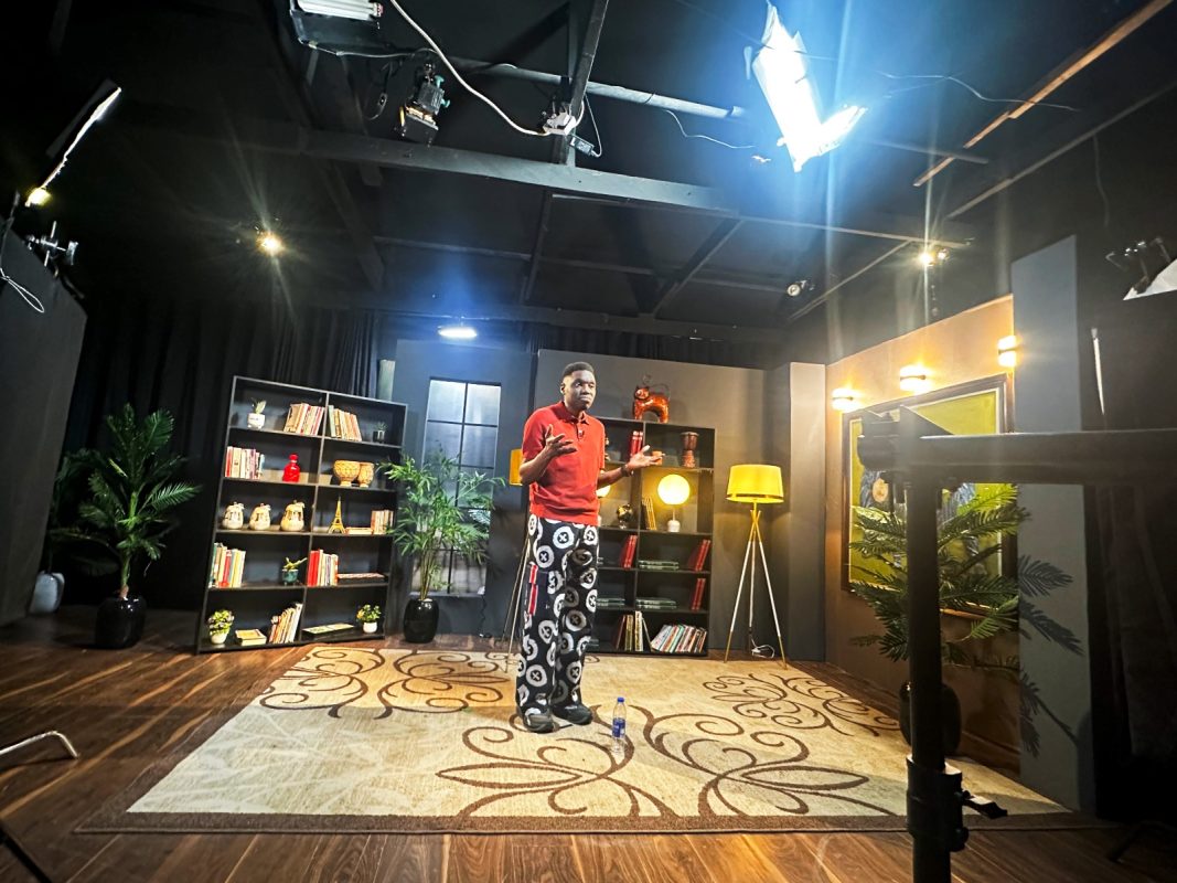 Dr Adeyinka Adewale filming in a studio