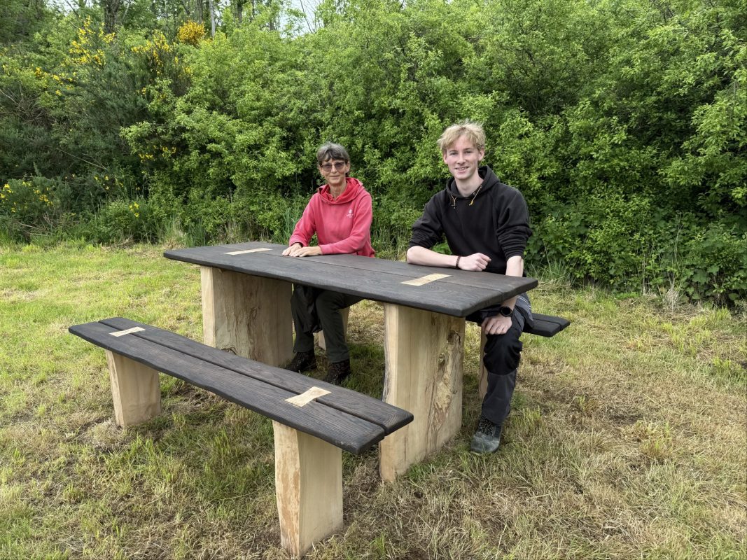 Fife College Furniture student Harrison Findlay and Jill Aitken, Site Manager for The Woodland Trust Scotland, are pictured at Formonthills Woodland, Glenrothes, with Harrison’s competition-winning bench design following its installation.