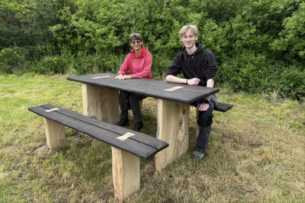 Fife College Furniture student Harrison Findlay and Jill Aitken, Site Manager for The Woodland Trust Scotland, are pictured at Formonthills Woodland, Glenrothes, with Harrison’s competition-winning bench design following its installation.
