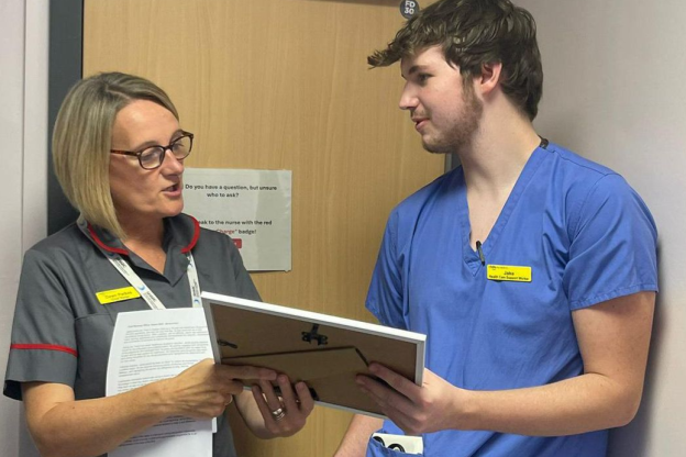 Jacob receiving the Chief Nursing Officer Award from his Matron