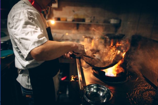 Someone cooking in a restaurant Stock
