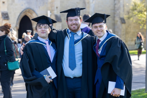Higher education students celebrating at graduation at Wiltshire College & University Centre