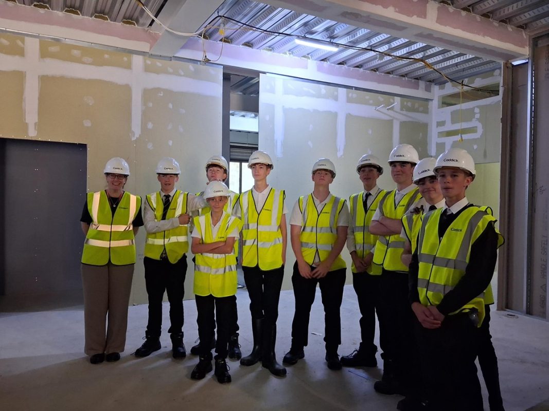 A group of Rossett School students, facing forward, visiting Harrogate College's under-construction new campus