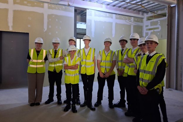 A group of Rossett School students, facing forward, visiting Harrogate College's under-construction new campus