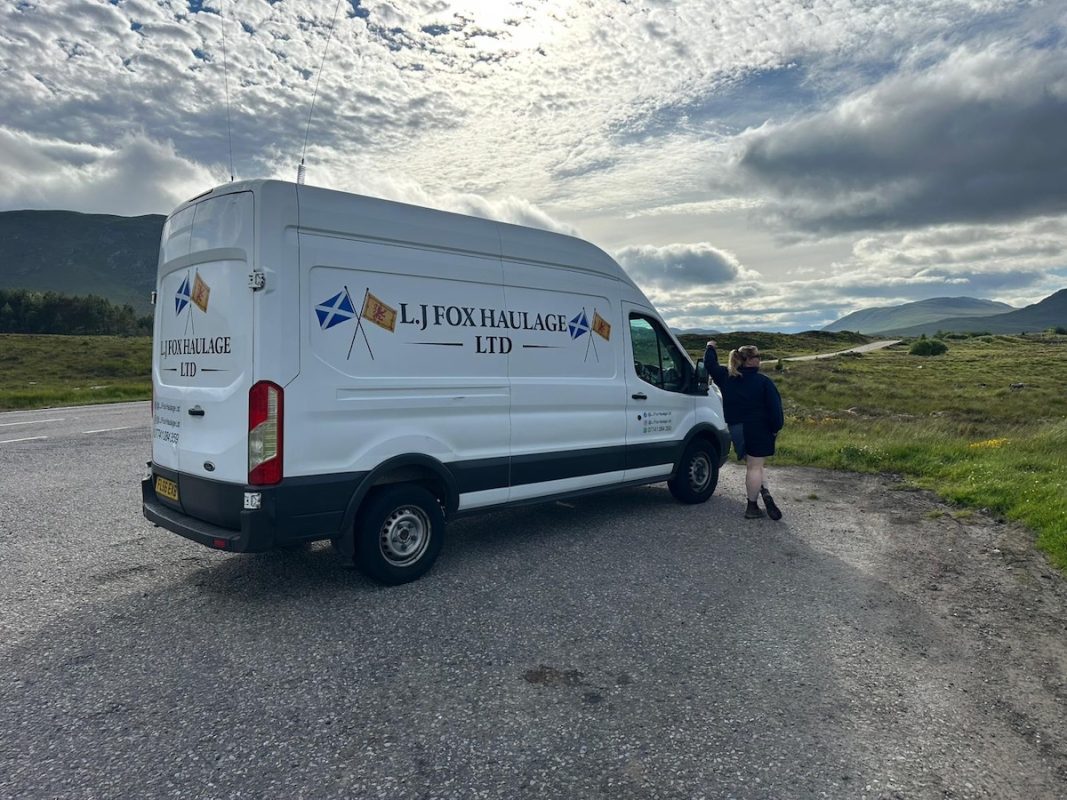 Photograph of Lilly Fox standing next to her van