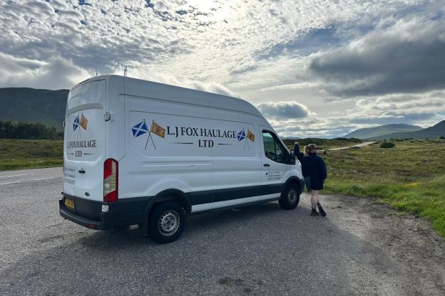 Photograph of Lilly Fox standing next to her van