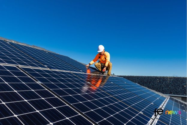 Man installing Solar Panels Stock