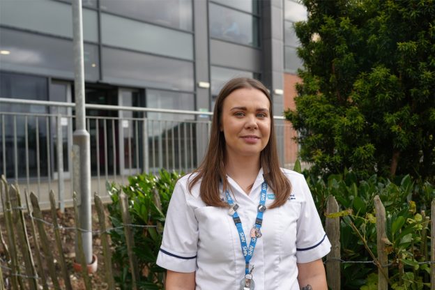 Coral Trainor in her healthcare uniform outside South Eastern Regional College