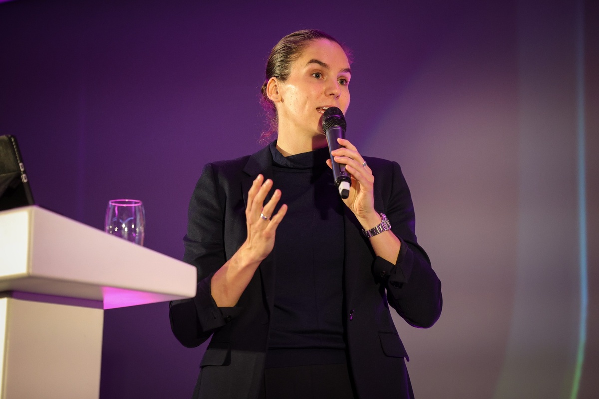 Esme Bianchi-Barry, CEO of Affinity Workforce Solutions, speaking at a podium during a conference presentation.