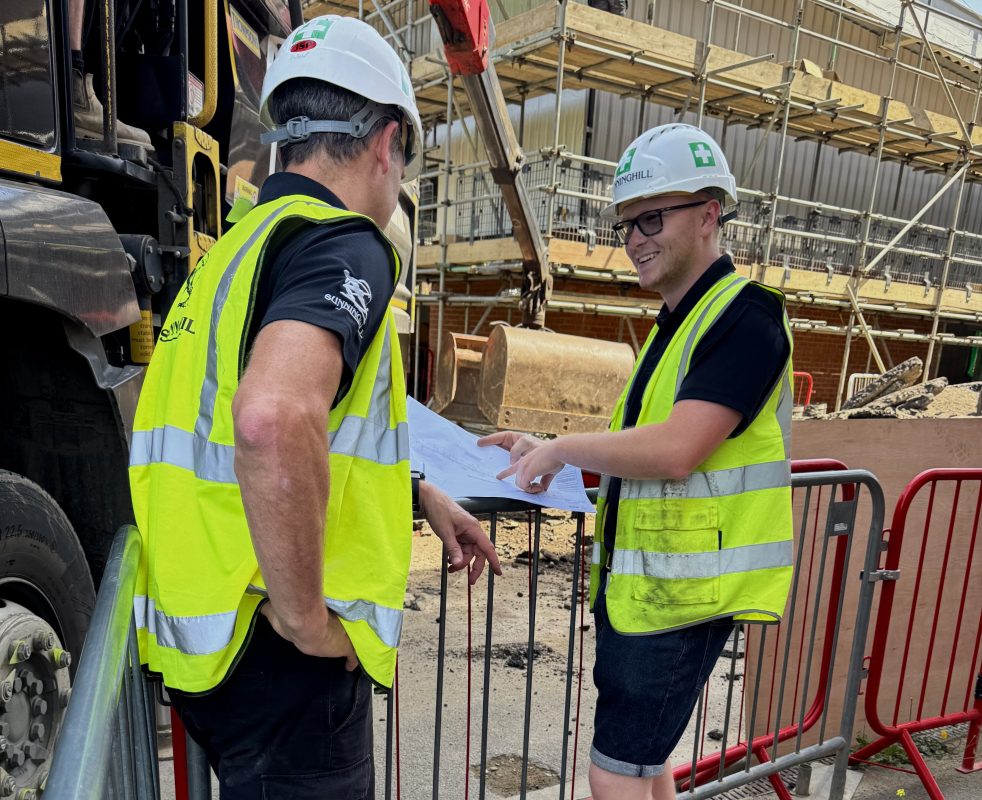 construction site image - two men talking in hard hats and high vis