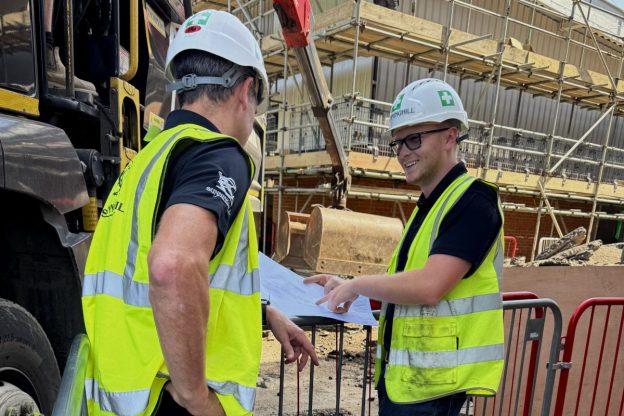 construction site image - two men talking in hard hats and high vis
