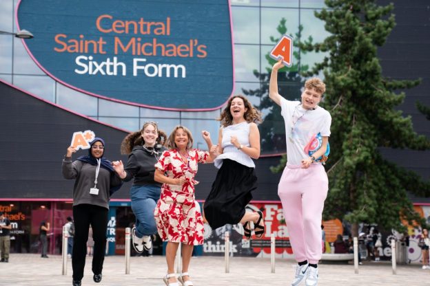 Principal Lisa Capper MBE with MP Sarah Coombes jumping to celebrate results with students