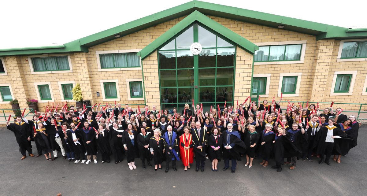 large group of Borders College graduates and staff standing outside a building