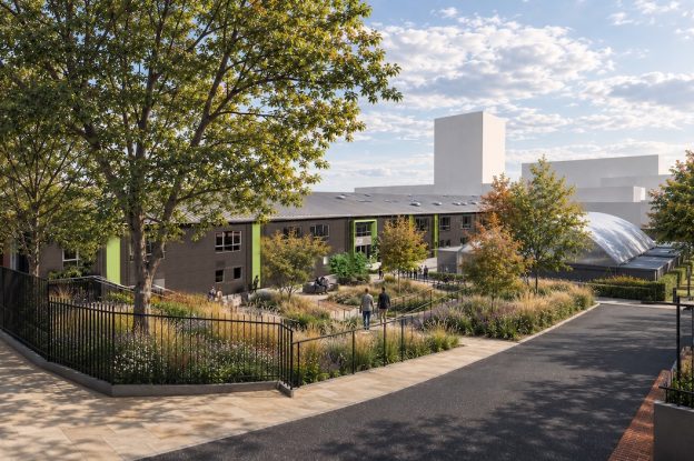 An impression of the planned Leeds College of Building CTEC building from Byron Street showing a large two-storey warehouse building in dark grey with green accents. Trees and people are scattered around the edges.