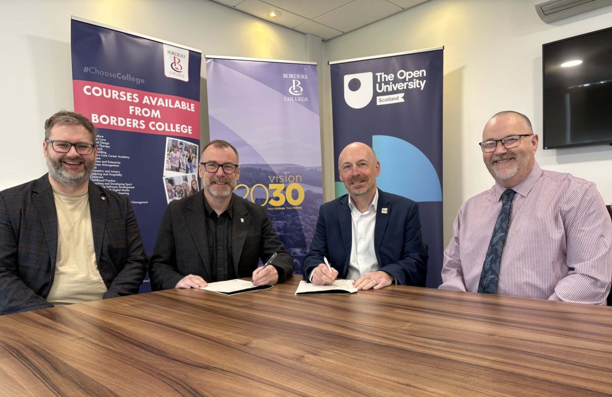 Photograph of 4 borders college and open university staff signing an agreement.