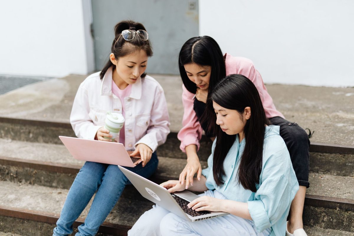 Students crowded around a laptop
