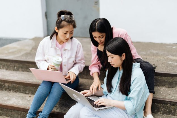 Students crowded around a laptop