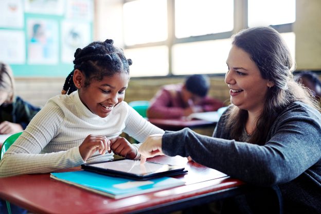 A teacher and a student in a classroom