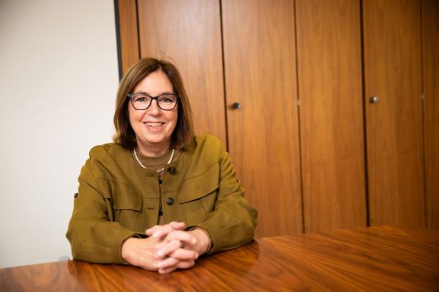 Ruth Sutherland sitting at a wooden table