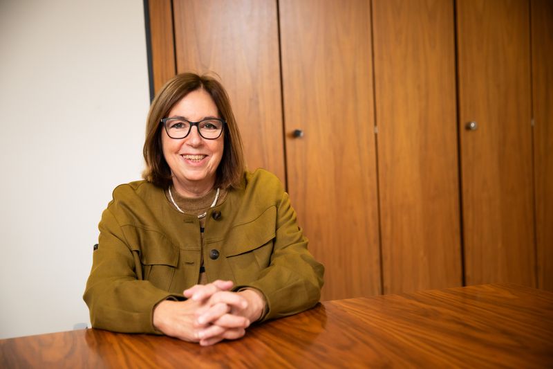 Ruth Sutherland sitting at a wooden table