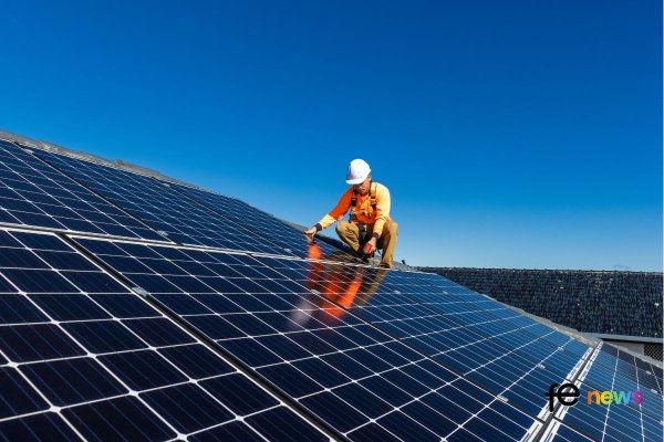 Man installing Solar Panels Stock