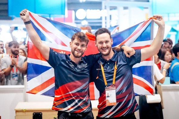 Joe Shingler holding a UK flag with another person